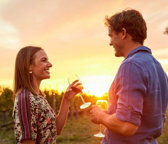 Couple enjoying wine at sunset at Swinging Bridge Wines, Orange.